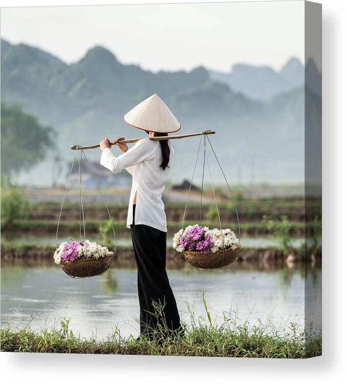 Three Quarter Length Canvas Print featuring the photograph Vietnamese Woman Carrying Baskets Of by Martin Puddy