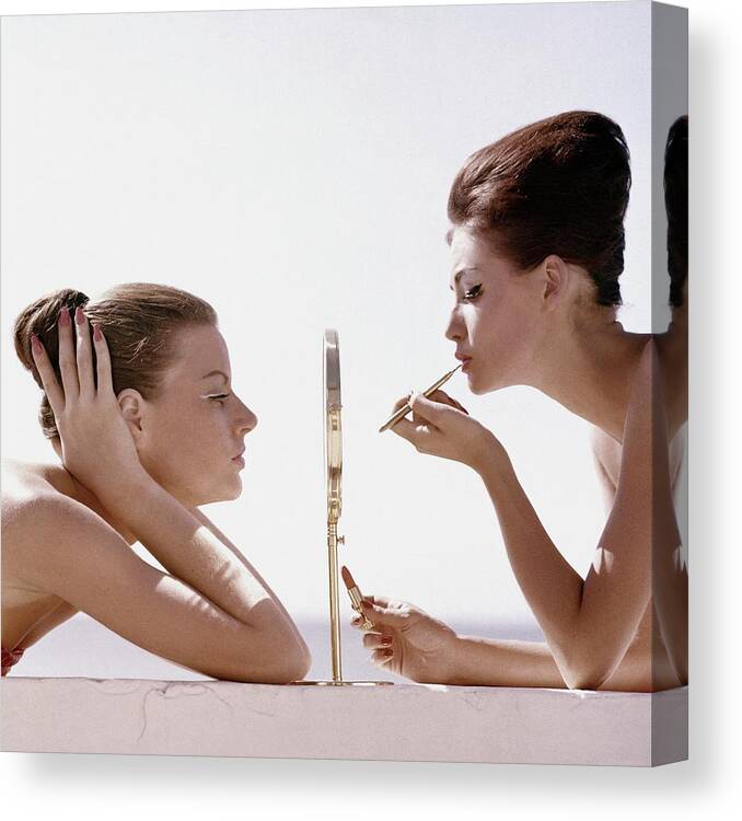Beauty Studio Shot Two People People Mirror Reflection Applying Lipstick Make-up Cosmetics Max Factor White Background Leaning Lip Brush 20-24 Years Young Adult 20s Adult Female Young Woman Young Adult Woman #condenastvoguephotograph April 1st 1960 Canvas Print featuring the photograph Women With A Mirror by Leombruno-Bodi