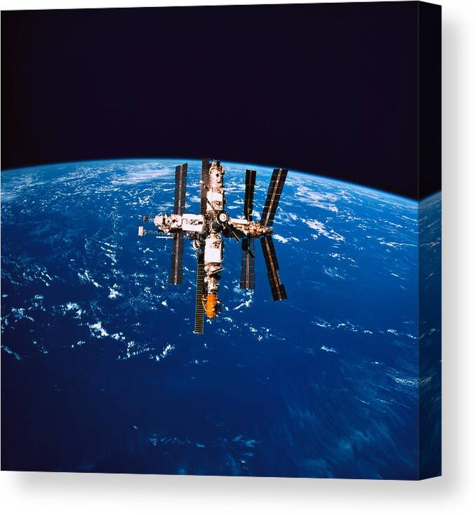 Horizontal Canvas Print featuring the photograph A Space Station In Orbit Above The Earth #1 by Stockbyte