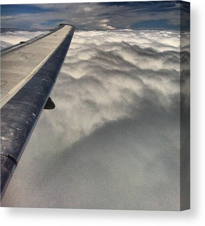 Clouds Canvas Print featuring the photograph View From The Plane Somewhere Over The by Arnab Mukherjee