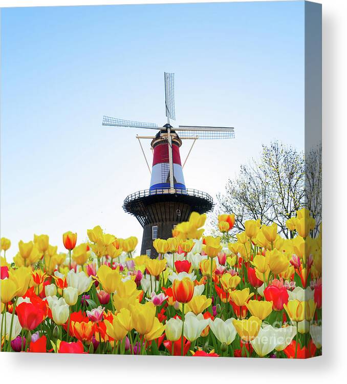 Amsterdam Canvas Print featuring the photograph Dutch Windmill with Netherlands Flag by Anastasy Yarmolovich