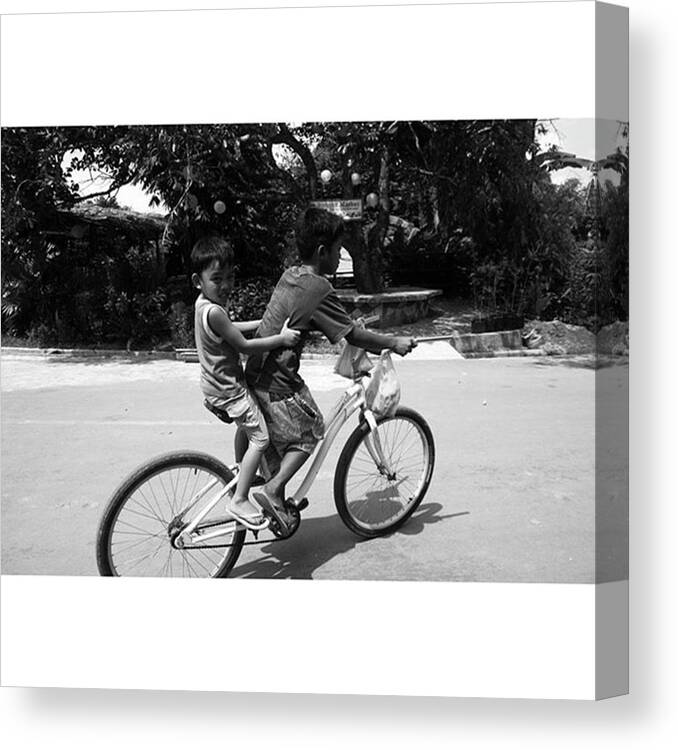 Youth Canvas Print featuring the photograph #kids #bike #youth by Jun Pinzon