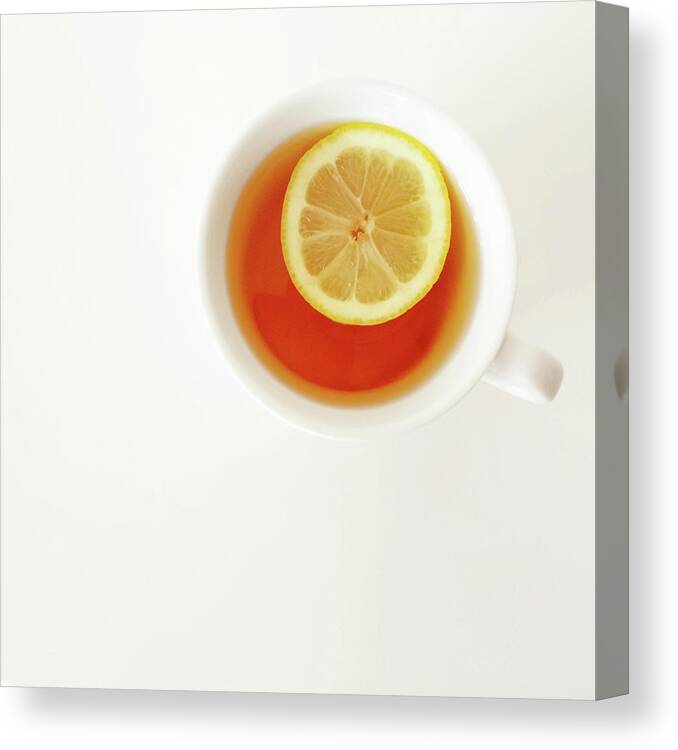 Tea Canvas Print featuring the photograph White cup of tea with lemon by GoodMood Art