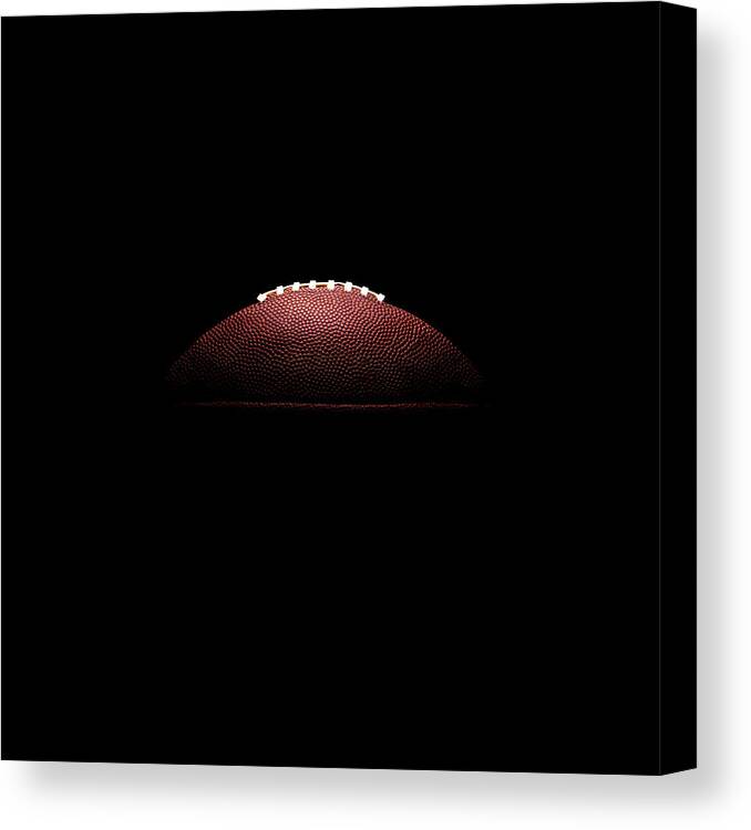 American Football Canvas Print featuring the photograph American Football Ball On Black by Thomas Northcut