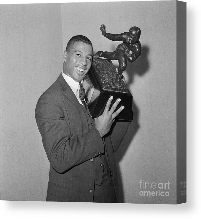 Art Canvas Print featuring the photograph Ernie Davis Holding Trophy by Bettmann