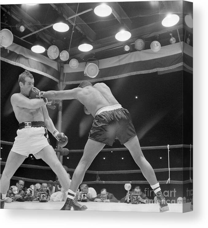 People Canvas Print featuring the photograph Floyd Patterson Hitting Ingemar by Bettmann
