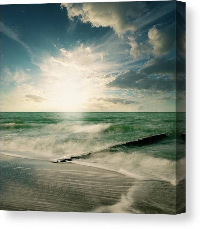 Water's Edge Canvas Print featuring the photograph Old Timber Pile In The Wavy Ocean by Ppampicture