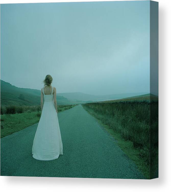 Dawn Canvas Print featuring the photograph Young Woman In Wedding Dress Looking by Dougal Waters