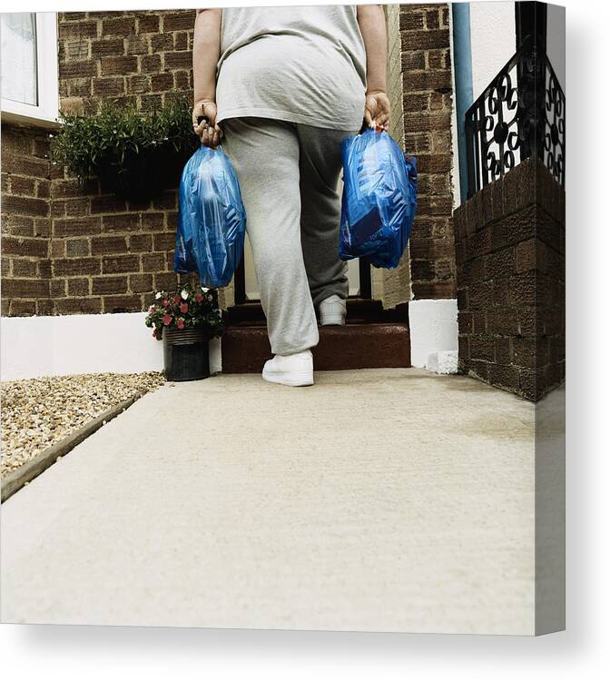 Overweight Canvas Print featuring the photograph Rear View of an Overweight Person Standing With Shopping Bags on a Doorstep by Digital Vision.
