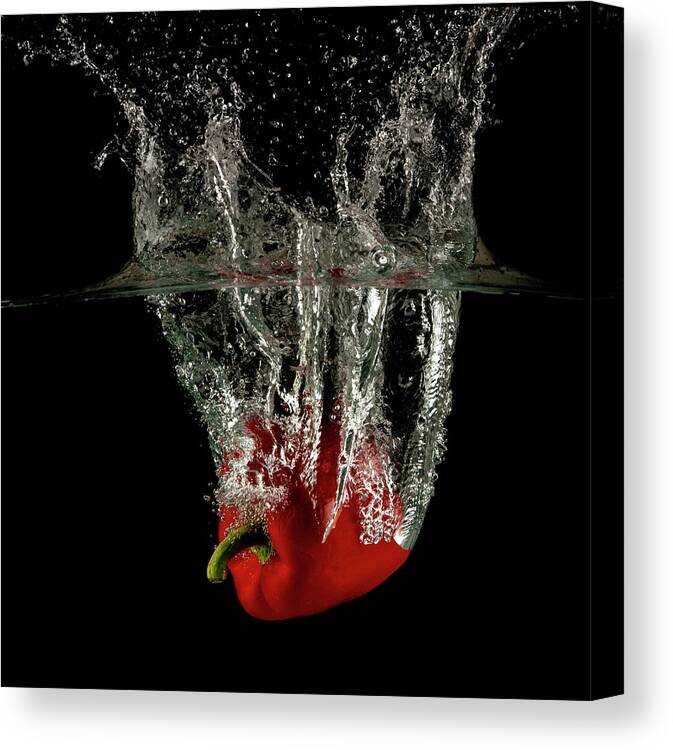 Pepper Canvas Print featuring the photograph Red bell pepper dropped and slashing on water by Michalakis Ppalis