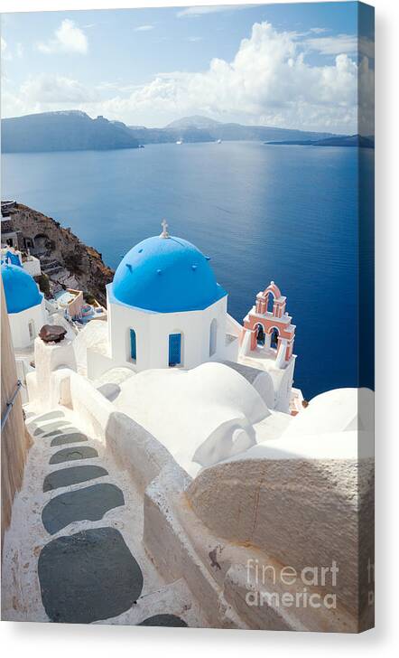 Santorini Canvas Print featuring the photograph Iconic blue domed churches in Santorini - Greece by Matteo Colombo
