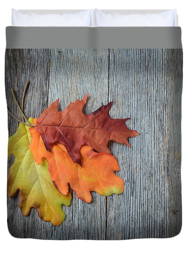Macro Duvet Cover featuring the photograph Autumn Leaves On Rustic Wooden Background #1 by Brandon Bourdages