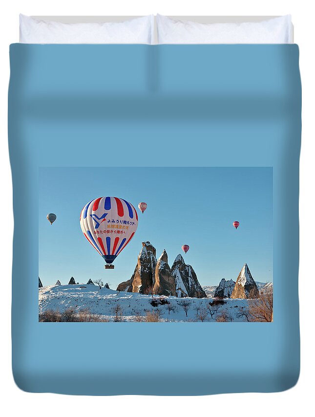 Wind Duvet Cover featuring the photograph Hot Air Balloons Over Snow Covered Rock #1 by Izzet Keribar