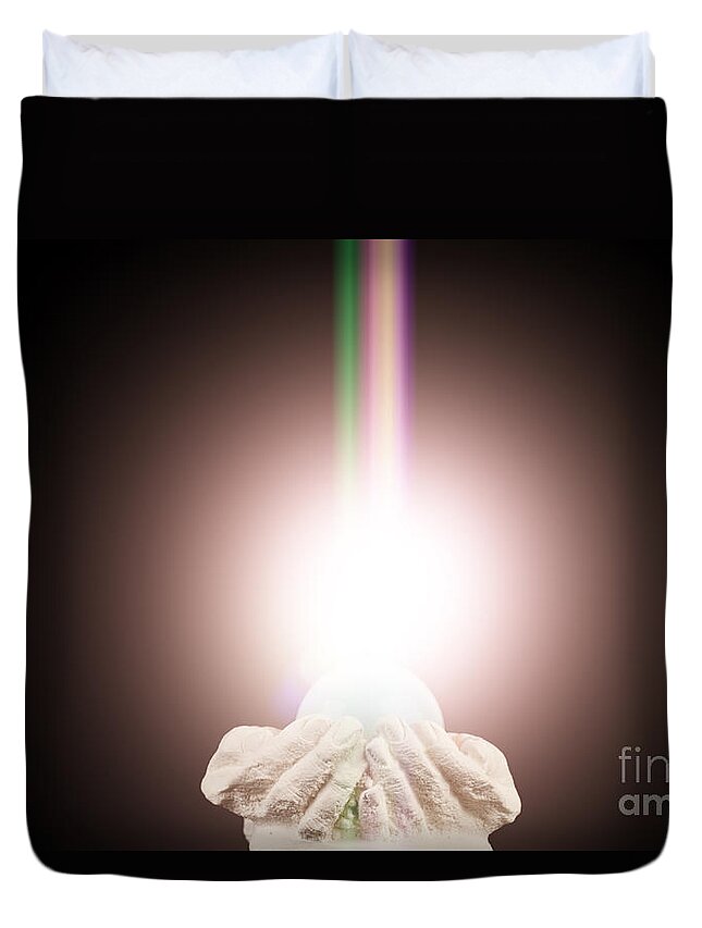  Spiritual Duvet Cover featuring the photograph Spiritual light in cupped hands on a black background by Simon Bratt