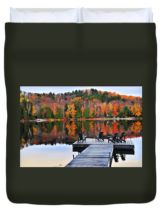 Lake Duvet Cover featuring the photograph Wooden dock with chairs on autumn lake by Elena Elisseeva
