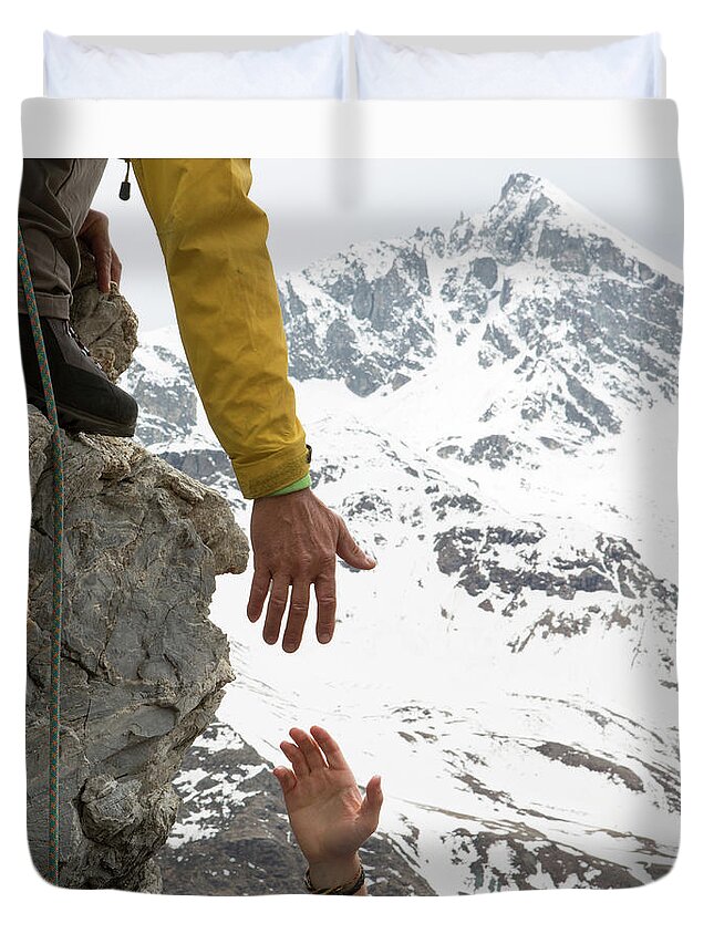Young Men Duvet Cover featuring the photograph Climber Offers Teammate A Helping Hand by Ascent Xmedia