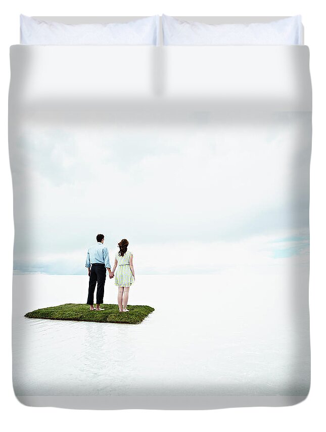 Young Men Duvet Cover featuring the photograph Couple On Small Island In Large Body Of by Thomas Barwick