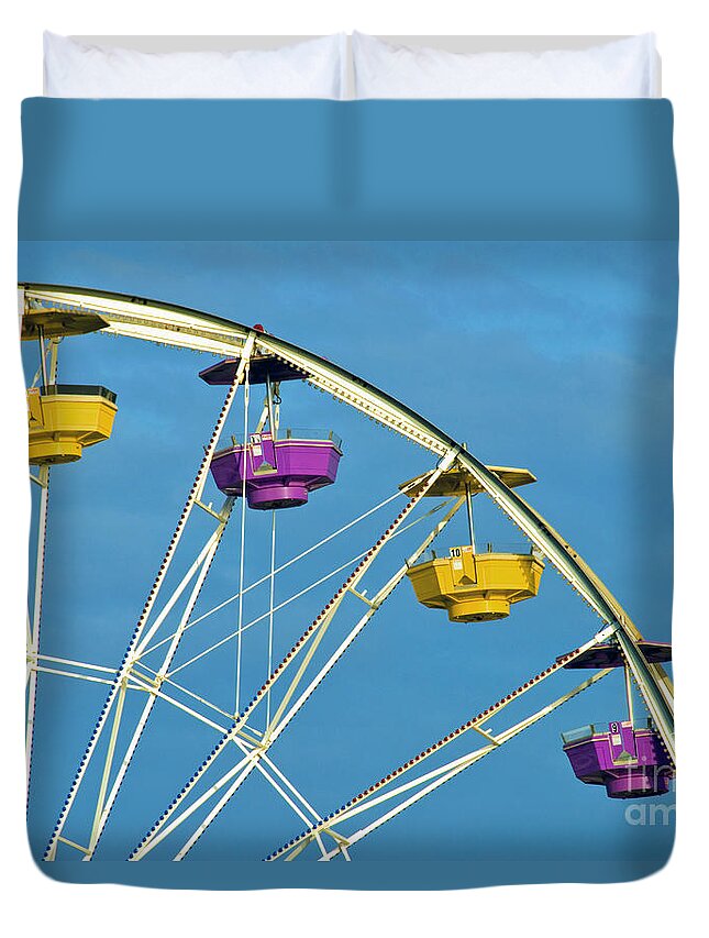 Ferris Wheel Duvet Cover featuring the photograph Ferris Wheel rotating upright wheel with passenger cars by David Zanzinger