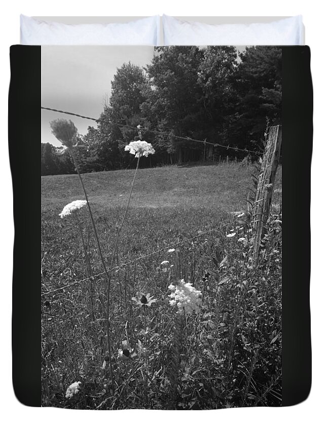 Kelly Hazel Duvet Cover featuring the photograph Flowers by a Barbed Wire Fence by Kelly Hazel