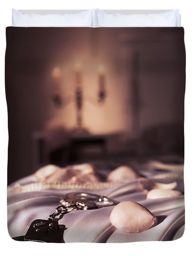 Bondage Duvet Cover featuring the photograph Handcuffs ropes and rose petals on bed BDSM sex romantic concept by Maxim Images Exquisite Prints