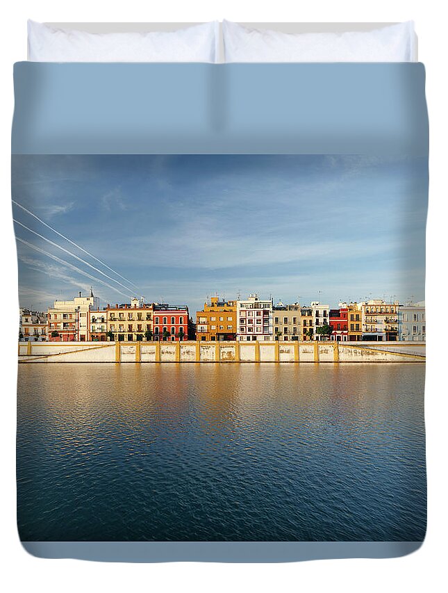 Tranquility Duvet Cover featuring the photograph Houses Along The River Guadalquivir In by Guy Vanderelst