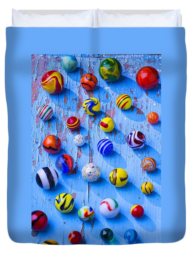 Marbles Duvet Cover featuring the photograph Marbles on blue board by Garry Gay