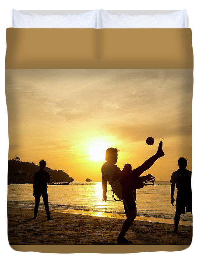 Young Men Duvet Cover featuring the photograph Men Playing Takraw Ball At Sunset On by Stuart Corlett / Design Pics