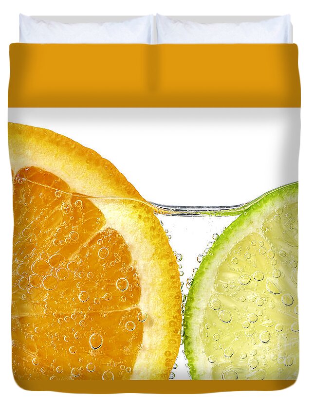 Orange Duvet Cover featuring the photograph Orange and lime slices in water by Elena Elisseeva