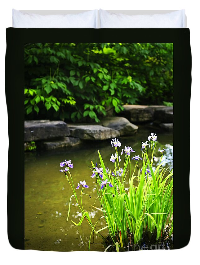 Garden Duvet Cover featuring the photograph Purple irises in pond by Elena Elisseeva