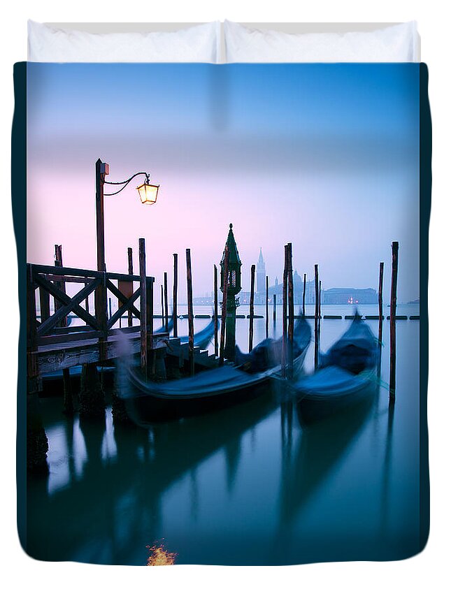 Gondolas Duvet Cover featuring the photograph Row of gondolas at sunrise in Venice - Italy by Matteo Colombo