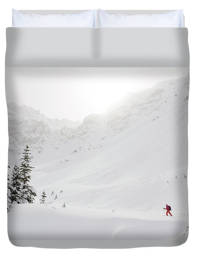 Skiing Duvet Cover featuring the photograph Skier Climbs Snowy Ridge Below Misty by Ascent Xmedia