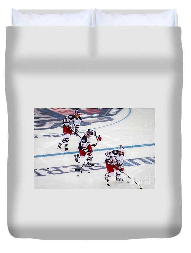 Faceoff Duvet Cover featuring the photograph Warming Up by David Rucker