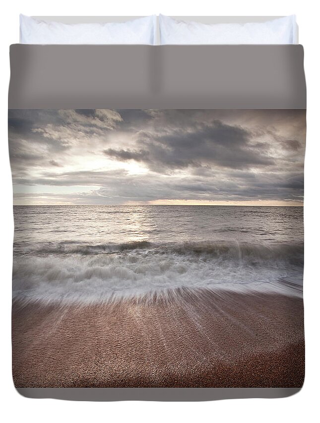 Tranquility Duvet Cover featuring the photograph Waves Crashing Over The Beach At Burton by Julian Elliott Photography