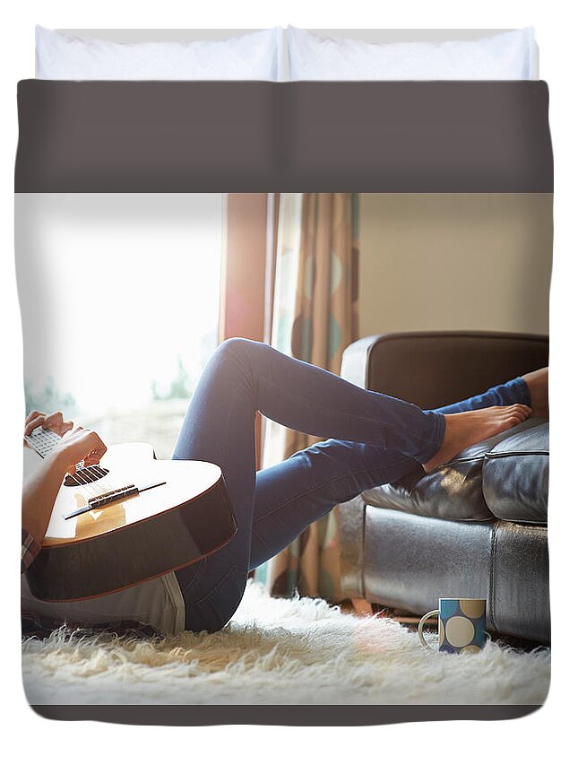 Rug Duvet Cover featuring the photograph Woman At Home Playing Guitar by Dougal Waters