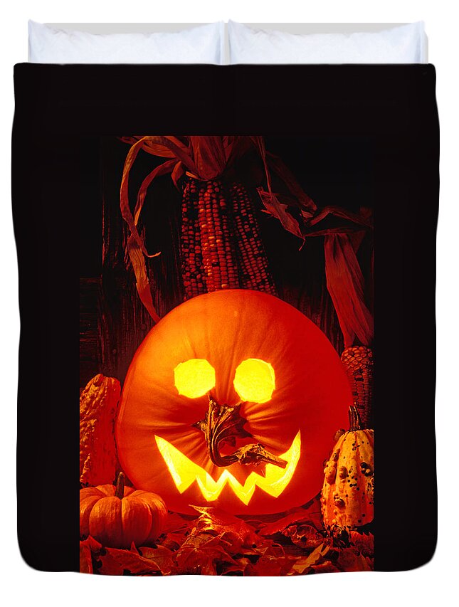 Pumpkin Duvet Cover featuring the photograph Carved pumpkin with fall leaves by Garry Gay