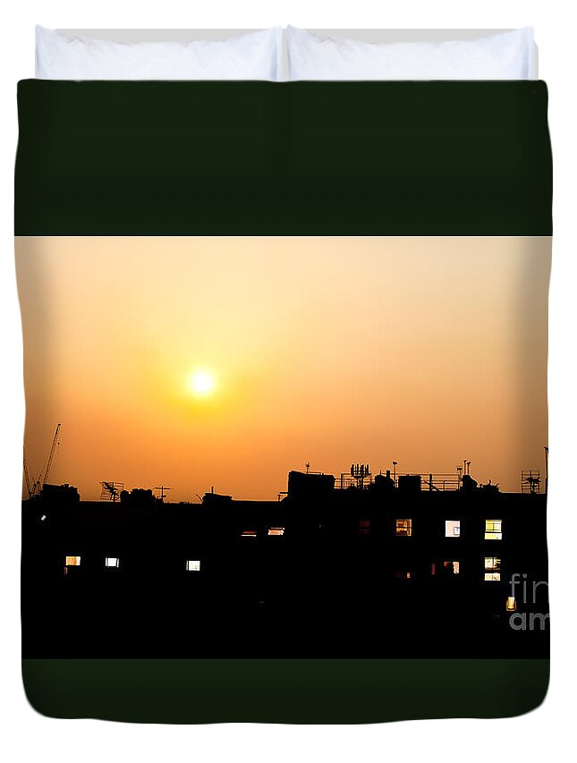 Night Duvet Cover featuring the photograph Sunset over rooftops with building lights by Simon Bratt