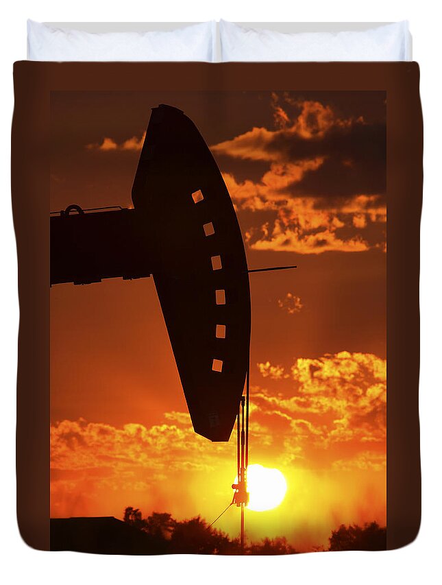 Oil Rig Duvet Cover featuring the photograph Oil rig pump jack silhouetted by setting sun #1 by Mark Duffy