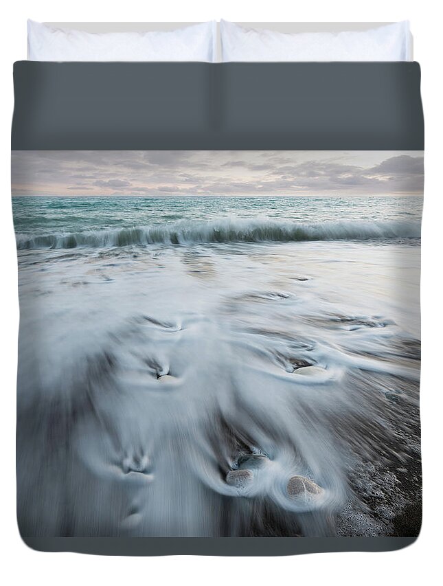 Coastline Duvet Cover featuring the photograph Pebbles in the beach and flowing sea water by Michalakis Ppalis