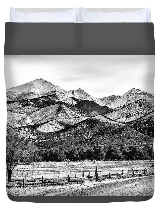 Coaldale; Colorado; Mountains; Rocky Mountains; Snow-capped Mountains; Winter; Evergreen; Trees; Fence; Wooden Fence; Road; Dirt Road; B/w Photo; Black And White Photograph; Black And White Photography; Black And White Pictures; Bw Photo Duvet Cover featuring the photograph 201702180-002K Road to mountains 2x3 by Alan Tonnesen