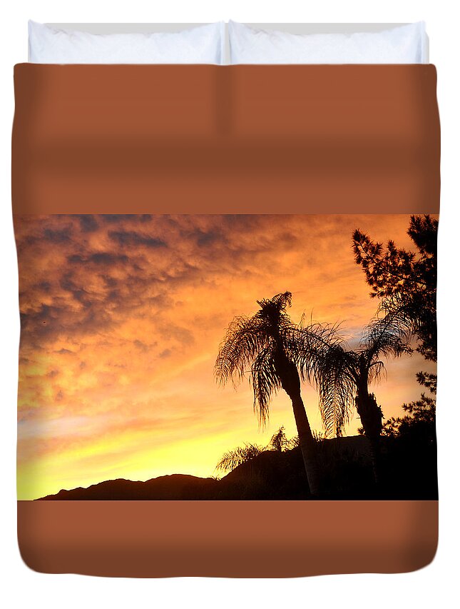 Sunset Duvet Cover featuring the photograph A Creamy Cloudy Sky At Sunset Thru The Queen Palm by Jay Milo