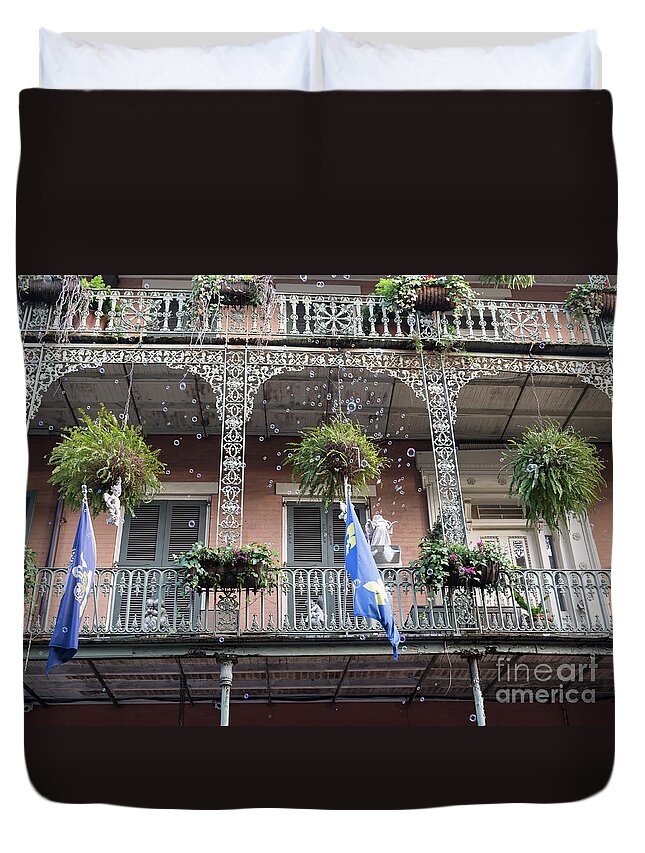 Wrought Iron Duvet Cover featuring the photograph Bubbles blow from an ornate balcony in New Orleans at Mardi Gras by Louise Heusinkveld