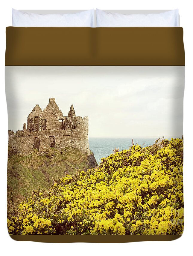 Ireland Duvet Cover featuring the photograph Castle ruins and yellow wildflowers along the Irish coast by Juli Scalzi
