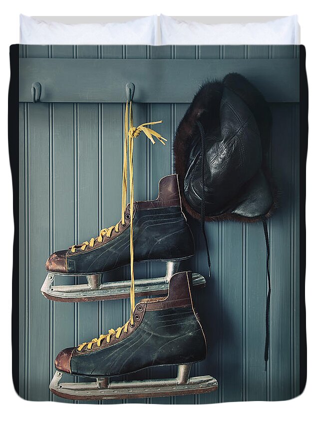 Aging Duvet Cover featuring the photograph Closeup of vintage men's skates and hat on hooks by Sandra Cunningham