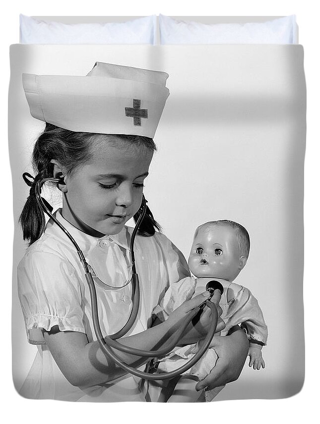 1960s Duvet Cover featuring the photograph Girl Playing Nurse With Doll, C.1960s by H Armstrong Roberts ClassicStock
