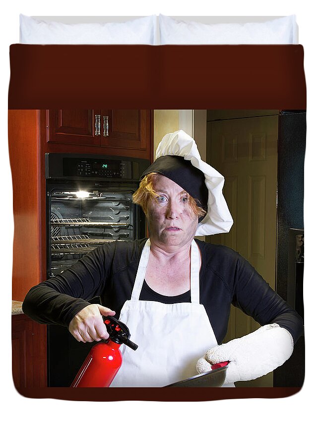 Burning Duvet Cover featuring the photograph Kichen disaster in apron with fire extinguisher and pan by Karen Foley