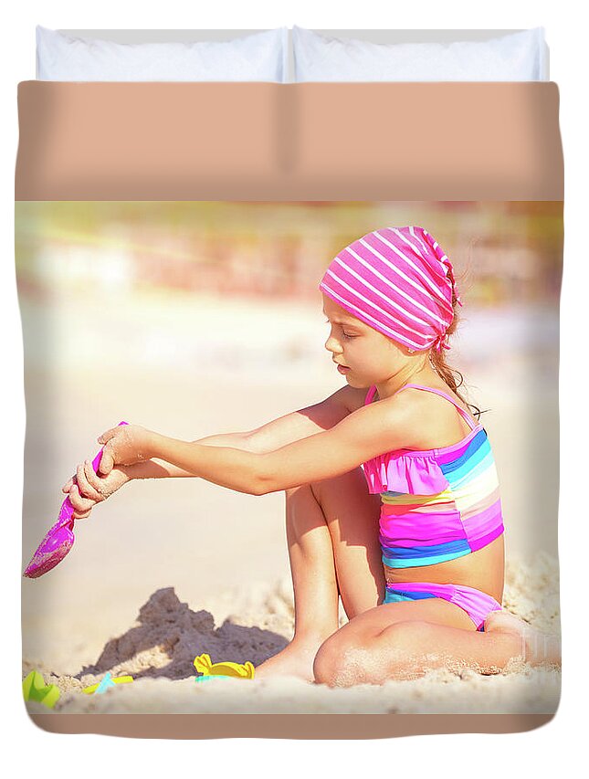 Active Duvet Cover featuring the photograph Little girl playing on the beach by Anna Om