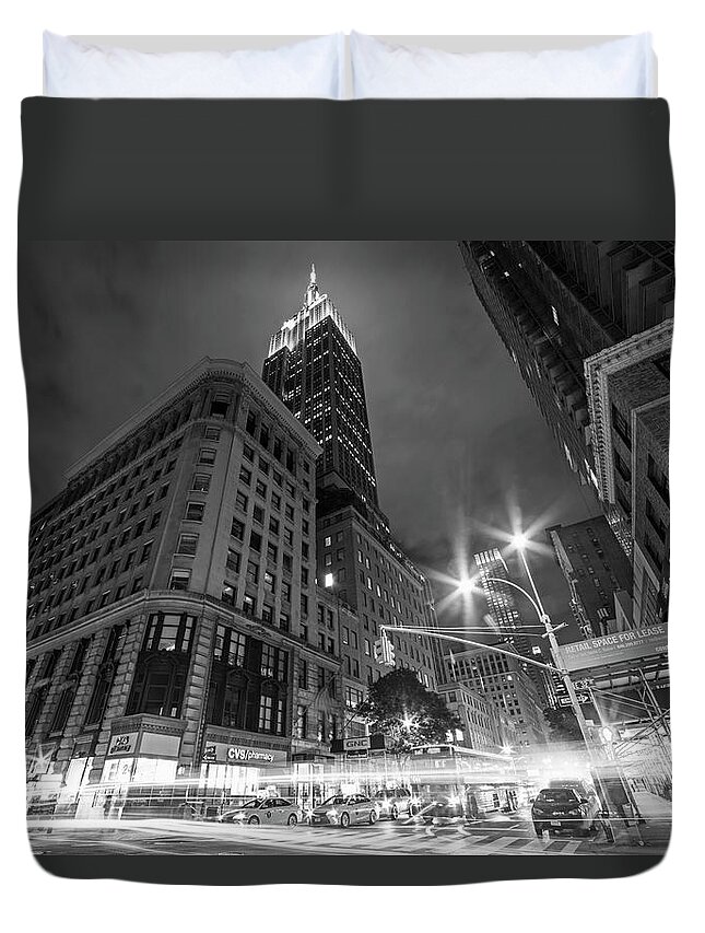 New.york Duvet Cover featuring the photograph Looking up at the Empire State building from Fifth Avenue at night New York NY Black and White by Toby McGuire