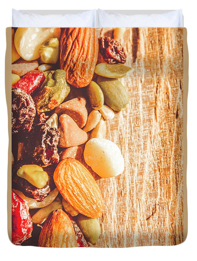 Nuts Duvet Cover featuring the photograph Mixed nuts on wooden background by Jorgo Photography