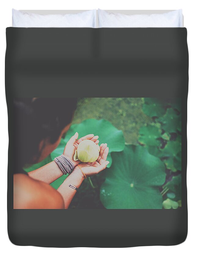 Bloom Duvet Cover featuring the photograph Portrait of a girl holding gently a lotus flower in her hands by Srdjan Kirtic