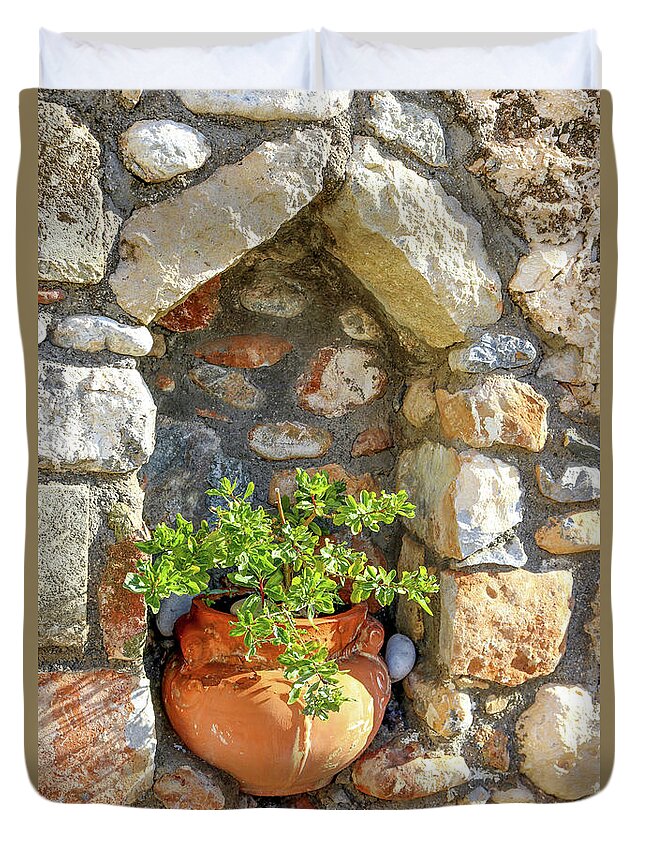 Charming Duvet Cover featuring the photograph Potted plant in niche in stone wall in Greek village by Susan Vineyard